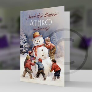May include: A Christmas card featuring a watercolor illustration of four children building a snowman in a snowy forest. The card has the text "Nadolig llawen ATHRO arbennig" in red cursive.