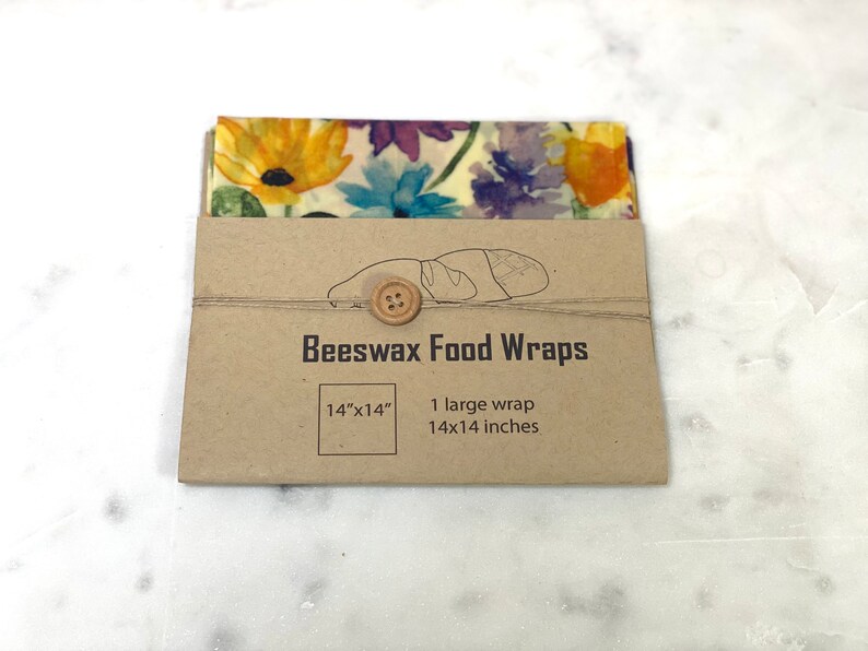May include: A brown paper package with a floral patterned beeswax food wrap inside. The package says "Beeswax Food Wraps" and "14"x"14" 1 large wrap 14x14 inches.