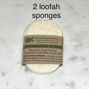 May include: Two natural loofah sponges with a brown paper label that reads "GreenLifeApothecary" and "DISHWASHING SPONGE". The label also includes care instructions for the sponges.