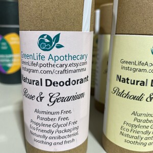Op de afbeelding: Twee kartonnen buizen met witte etiketten. Het etiket op de linker buis luidt "GreenLife Apothecary GreenLifeApothecary.etsy.com Instagram.com/craftimamma Natuurlijke deodorant Rozen & Geranium Aluminiumvrij, Paraben vrij, Propylenglycol vrij Ecologisch verpakte Natuurlijk antibacterieel, verzachtend en fris". Het etiket op de rechter buis luidt "GreenLifeAp instagram.co Natuurlijke deodorant Patchouli & Aluminium Paraben Propylenglycol G Ecologisch verpakte Natuurlijk ant verzachtend ar".