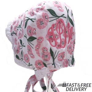 Melondipity Monogram Baby Bonnet with Pink Flower Patterns, Double Ruffle White Eyelet Brim Bonnet with Self Fabric Chin Ties for Baby Girl