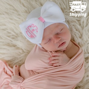 Melondipity Newborn Girl&#39;s White Hospital Hat with Embroidered on One Side of White Bow, and Pink Ribbon at Center | Double Ply Extra Warmth