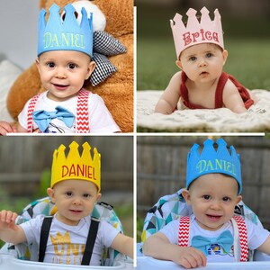 May include: Four babies wearing personalized felt crowns. The crowns are blue, pink, yellow, and blue. The babies are wearing different outfits, including a white shirt with red suspenders, a red shirt, and a white shirt with a graphic.