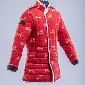 May include: Red quilted jacket with a white trim and gold lion pattern. The jacket has a button closure and a stand-up collar.