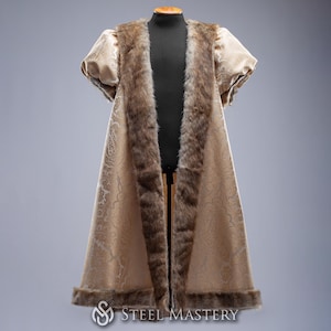 May include: A long, cream-colored robe with a brown fur trim. The robe has a  pattern of small, white flowers. The robe is on a mannequin.