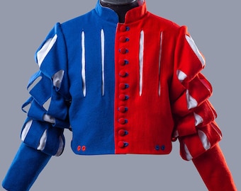 May include: A two-toned, historical-style jacket, half blue and half red, with white accents. The jacket features a high collar, button closures, and layered sleeves. The garment is displayed on a black mannequin head against a gray background.