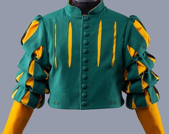Peut inclure: Un pourpoint vert et jaune avec un col montant et une fermeture boutonnée. Les manches présentent des détails superposés et à volants verts et jaunes. Le vêtement est présenté sur une tête de mannequin noire. Le logo Steel Mastery est en bas.