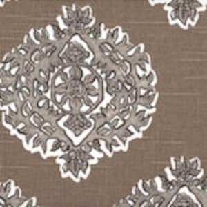 May include: A brown fabric with a white and gray geometric pattern. The pattern features a repeating design of stylized leaves and flowers.