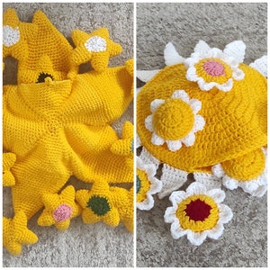 May include: Two crocheted yellow flower-shaped items. One is a flat, circular flower with white petals and a yellow center. The other is a three-dimensional star-shaped flower with white and yellow accents.