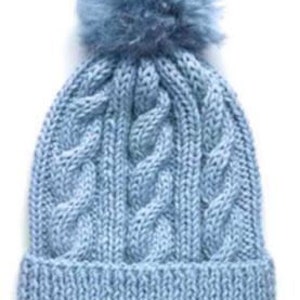 May include: A light blue knitted beanie with a fluffy pom pom on top. The beanie has a cable knit pattern.