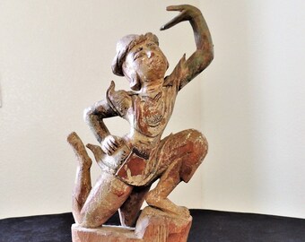 Old hand carved wood Asian statue.