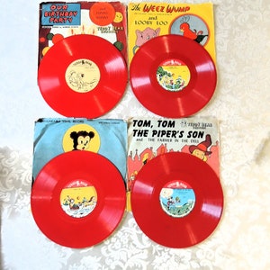 May include: Four red vinyl records with colorful book covers. The covers feature illustrations of a birthday party, a bunny, a bird, and a piper's son. The records are labeled "Teddy Bear Records".