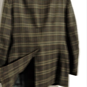 May include: A brown and green plaid blazer with a single vent in the back.