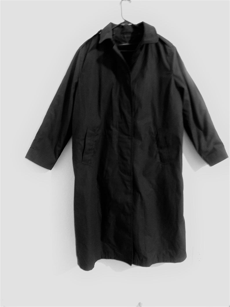 May include: A long black raincoat with a collar and pockets.