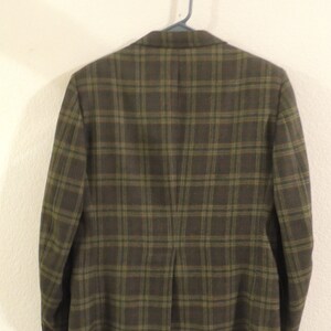 May include: A brown and green plaid blazer with a single vent in the back.