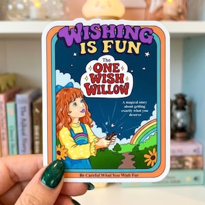May include: A rectangular sticker featuring a cartoon illustration of a girl with red hair holding a branch. The text reads: WISHING IS FUN, The ONE WISH WILLOW, A magical story about getting exactly what you deserve, and Be Careful What You Wish For.