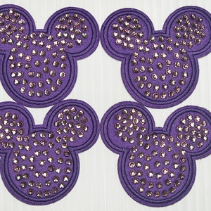 May include: Four purple felt Mickey Mouse head patches with silver rhinestones.
