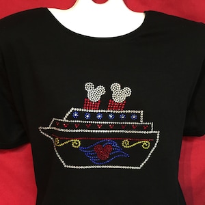 May include: Black t-shirt with a rhinestone design of a cruise ship with Mickey Mouse characters on top. The ship has red, white, and blue accents.