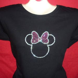 May include: Black t-shirt with a rhinestone design of Minnie Mouse's head with a pink bow.