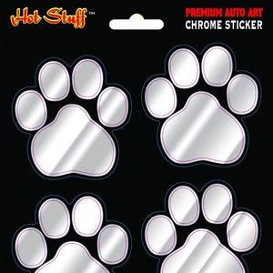 May include: Four silver chrome paw print stickers. The stickers are on a black background and have a purple outline. The text "PREMIUM AUTO ART CHROME STICKER" is at the top of the image. The text "www.hotstuffmerchandise.com" is at the bottom of the image.