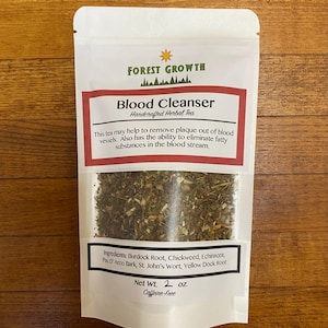 May include: A white pouch with a red and white label that reads "Forest Growth Blood Cleanser Handcrafted Herbal Tea". The label also includes a list of ingredients: Burdock Root, Chickweed, Echinacea, Pau D'Arco Bark, St. John's Wort, Yellow Dock Root. The pouch contains a blend of dried herbs. The label also states "Net Wt. 2 oz. Caffeine-Free".