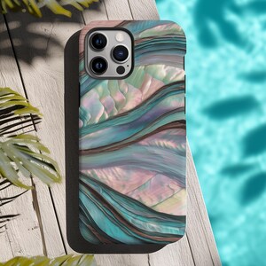 May include: A smartphone case with a colorful abstract design. The case features a pattern of flowing lines in shades of teal, pink, and brown, resembling a watercolor painting. The case has a black border and a camera cutout.