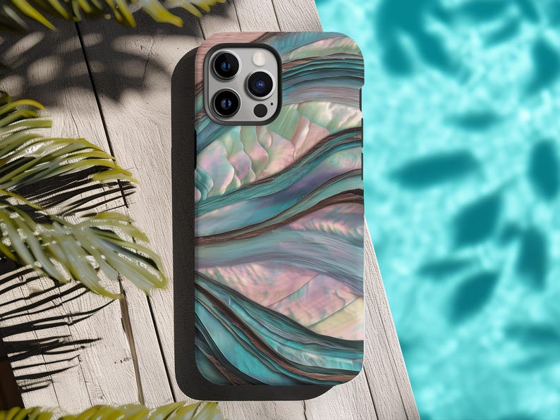 May include: A smartphone case with a colorful abstract design. The case features a pattern of flowing lines in shades of teal, pink, and brown, resembling a watercolor painting. The case has a black border and a camera cutout.