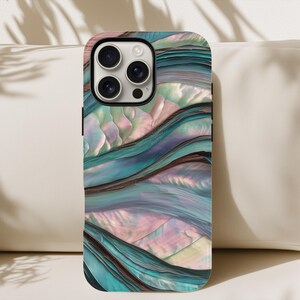 May include: A smartphone case with a swirling, iridescent design in shades of teal, blue, and pink. The case has a glossy finish and a camera cutout. The design resembles the texture of abalone shells.