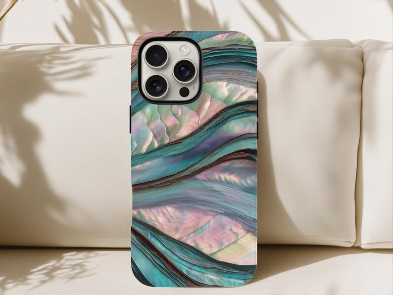 May include: A smartphone case with a swirling, iridescent design in shades of teal, blue, and pink. The case has a glossy finish and a camera cutout. The design resembles the texture of abalone shells.