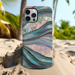 May include: A smartphone case with a flowing, abstract design in shades of teal, brown, and pink. The case has a glossy finish and a multi-camera lens cutout. The background shows a sandy beach and palm trees.