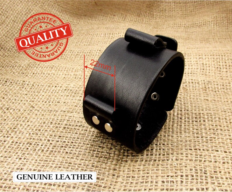 May include: Black leather bracelet with a buckle closure and silver rivets. The bracelet is 22mm wide.  GENUINE LEATHER.
