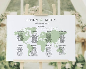 May include: A green and white world map wedding seating chart with the names of guests listed under different cities. The chart is on a wooden easel with the text "Jenna & Mark" and "10th August 2022" at the top.