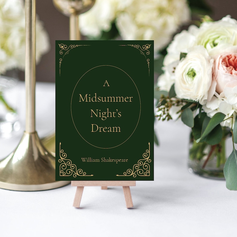 May include: A green card with gold lettering on a wooden easel. The card reads "A Midsummer Night's Dream" by William Shakespeare.