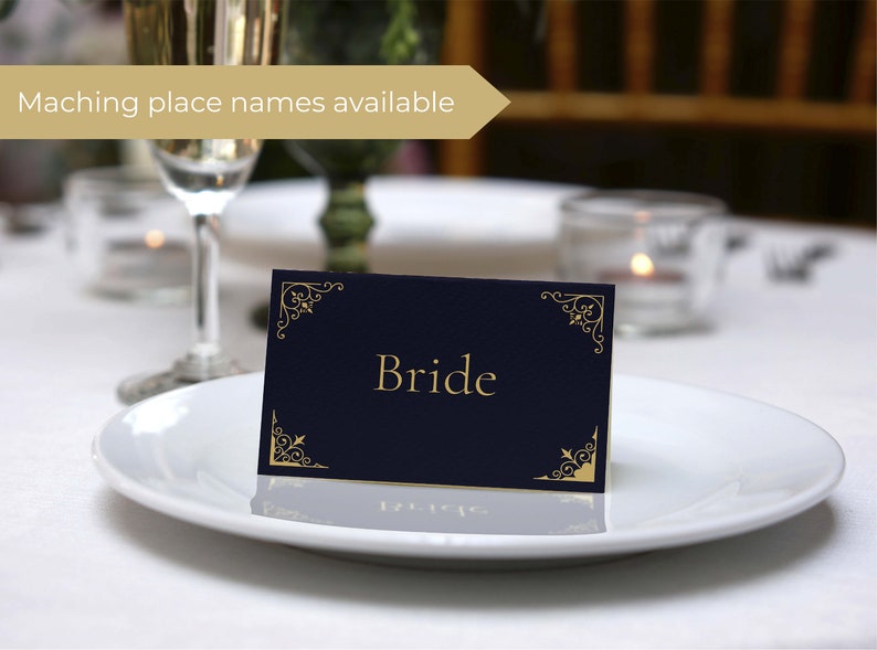 May include: A navy blue place card with gold ornate corners and the word "Bride" printed in gold lettering.