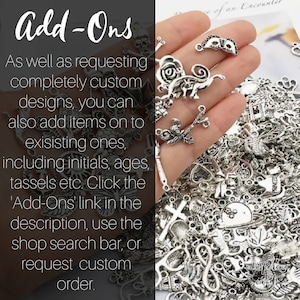 May include: A close-up of a hand holding a variety of silver charms, including a skull, a mask, a bird on a branch, a butterfly, a cross, and a heart. The charms are for adding to jewelry or other crafts. The text 'Add-Ons' is visible in the image.