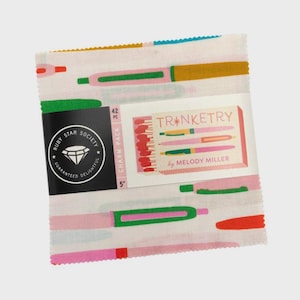 May include: A fabric charm pack featuring a repeating pattern of colorful pens in pink, green, and gold on a white background. The pack includes a label with the text "TRINKETRY by MELODY MILLER" and a Ruby Star Society logo. Each square measures 5 inches.