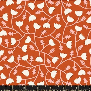 May include: A red fabric with a white and pink floral pattern. The pattern features stylized flowers with rounded petals and curved stems. The fabric has a repeating pattern.