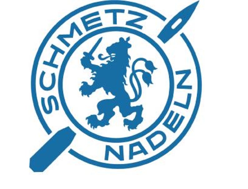 May include: A blue circular logo with the text "SCHMETZ NADELN" around the edge. Inside the circle is a blue lion with a sword in its paw and a needle and thread design above the lion.