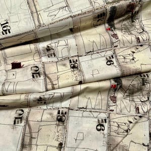 May include: A white fabric with a repeating pattern of black lines and numbers. The fabric has a textured surface and appears to be woven.