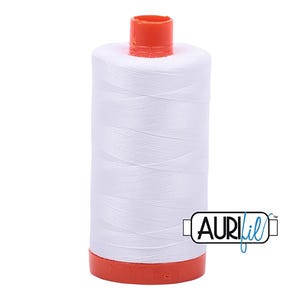 May include: A white spool of thread with an orange top and base. The thread is tightly wound around the spool. The brand name "AURIfil" is printed on the side of the spool.