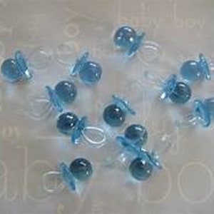 May include: A group of 15 light blue plastic baby pacifier charms. The charms are about 1 inch in size and are perfect for adding a touch of whimsy to baby shower decorations or crafts.