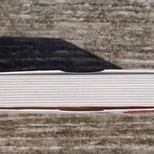 May include: A white cardboard box with a slightly textured surface. The box is closed and appears to contain a set of items.