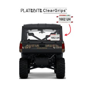 May include: Black Polaris utility vehicle with a camouflage design on the rear. The vehicle has a Wisconsin license plate with the number 1662 UH. The product name "PLATE BITE ClearGrips" is displayed at the top.