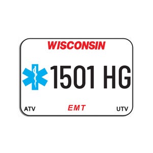 Puede incluir: Una placa de matrícula rectangular blanca con esquinas redondeadas que presenta el texto rojo WISCONSIN en la parte superior. Muestra un símbolo azul de la Estrella de la Vida, el código alfanumérico negro 1501 HG y el texto rojo EMT, con ATV y UTV en negro.