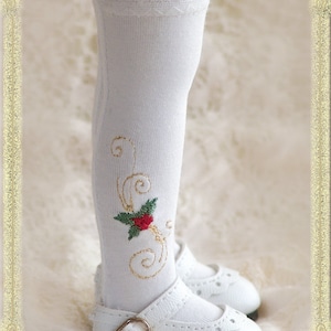 May include: White knee-high socks with a gold embroidered floral design and a red flower. The socks have a white lace trim at the top. The socks are paired with white shoes with a buckle.