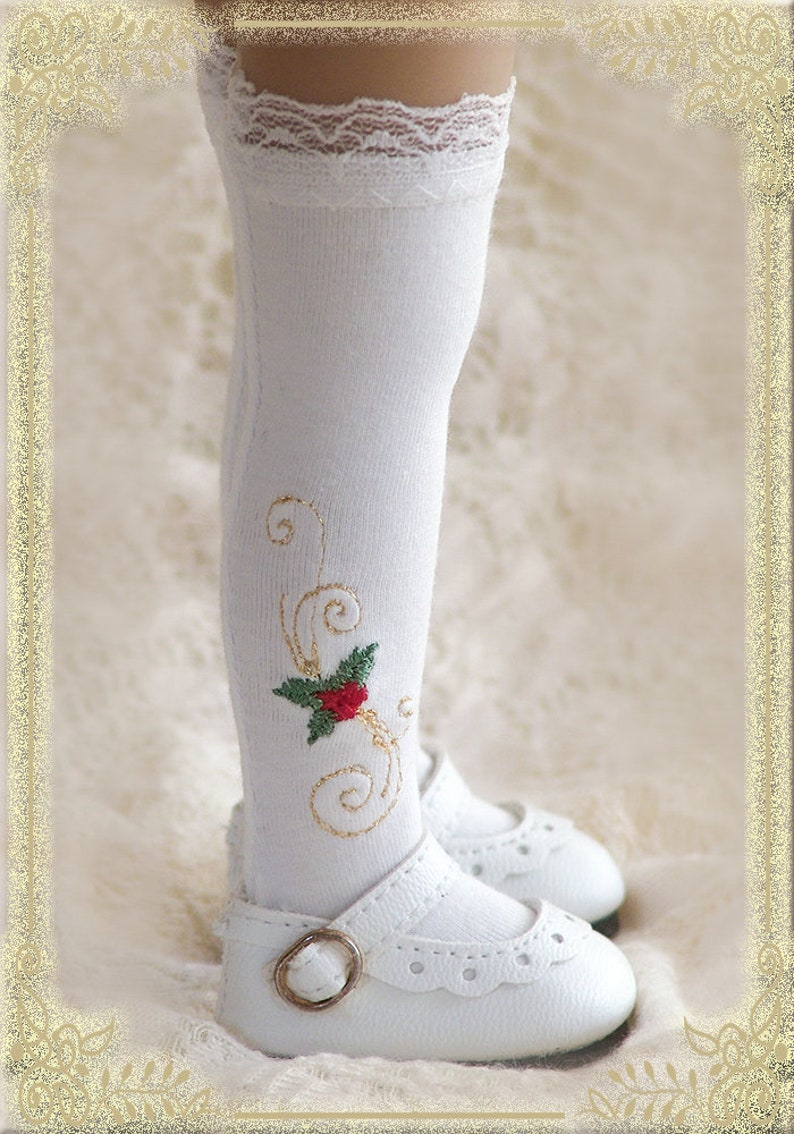 May include: White knee-high socks with a gold embroidered floral design and a red flower. The socks have a white lace trim at the top. The socks are paired with white shoes with a buckle.