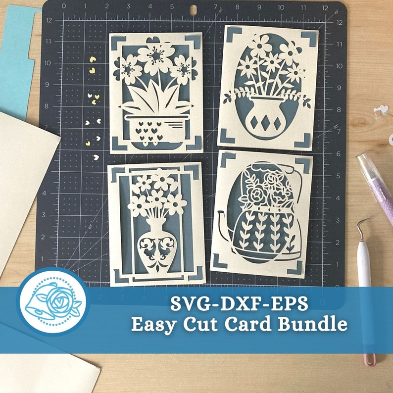 May include: Four cream-colored, laser-cut greeting cards with floral designs, including flowers in a pot, vase, and teapot. The cards are set against a teal background on a cutting mat. The text "SVG-DXF-EPS Easy Cut Card Bundle" is at the bottom.