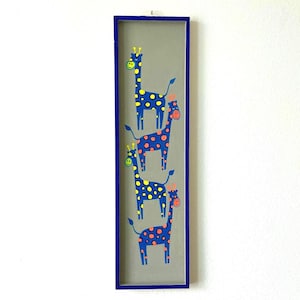 May include: A rectangular wall art piece featuring four blue giraffes with yellow spots and orange accents. The giraffes have smiling faces and are set against a gray background within a blue frame. This whimsical artwork is suitable for a child's room.