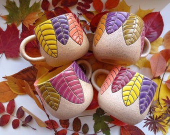 Colorful handmade ceramic mug with leaves