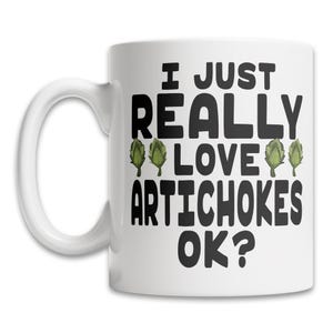 May include: White ceramic coffee mug with a black and green design. The mug has a black handle and the text "I just really love artichokes ok?" printed on the front.